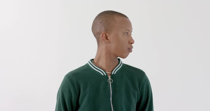 High-speed photography for dynamic scenes, young man in green jacket standing and looking directly a