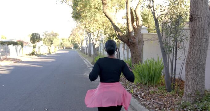 Lifestyle videos outdoor of people doing activities, Running outdoors, woman jogging on suburban str