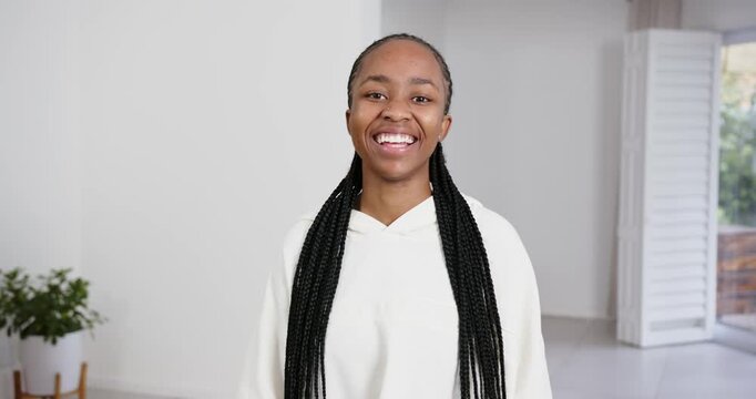 High speed photography for dynamic scenes, smiling woman with long braids wearing white hoodie, stan
