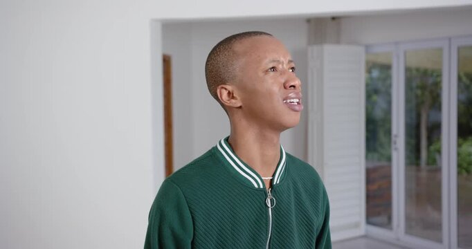 High speed photography for dynamic scenes, man in green jacket looking confused, standing indoors wi