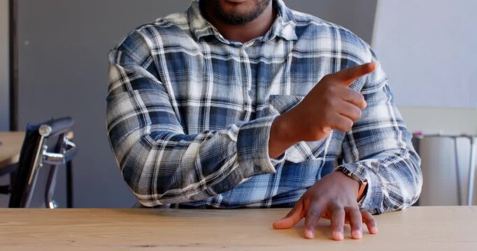 Close up of people talking to the camera, pointing to side, man in plaid shirt sitting at wooden tab