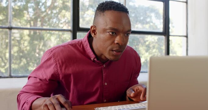Lifestyle videos indoor of people doing activities at office, working on laptop, man in red shirt fo