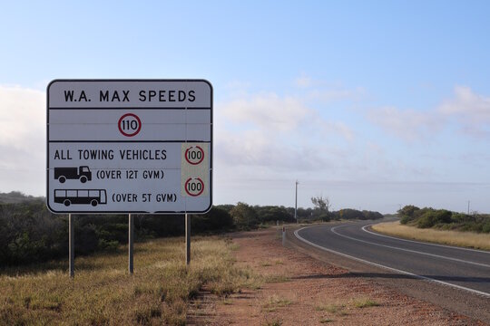 Large white maximum speeds regulations road sign on highway landscape in rural Western Australia. Highlighting transport speed limits,  caution warming. Towing and heavy vehicles. Copy space