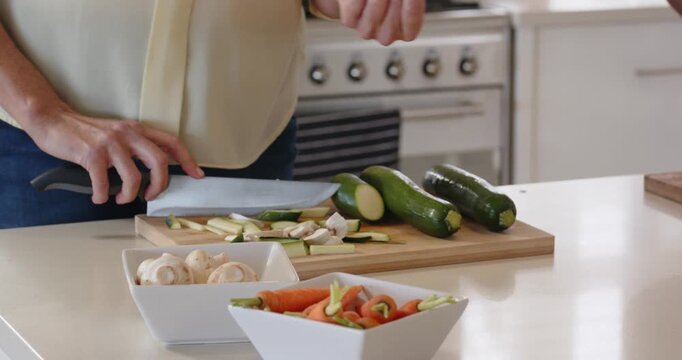 Lifestyle videos indoor of people doing activities at home, Chopping vegetables on cutting board, pe