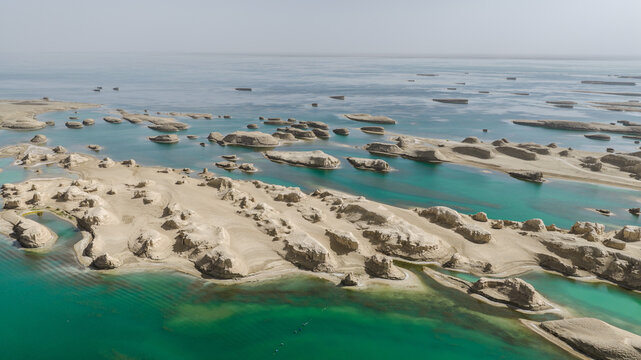 Aerial View of Yardang Landforms and Turquoise Water in a Desert Landscape
