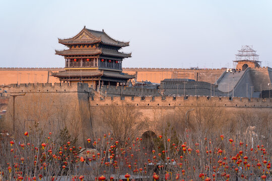 Ancient Chinese City Wall Gate Tower with Red Lanterns in Winter