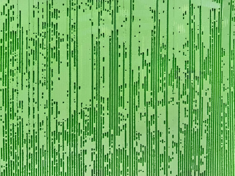Abstract full frame background of weathered wooden plank texture with green painted grain lines.