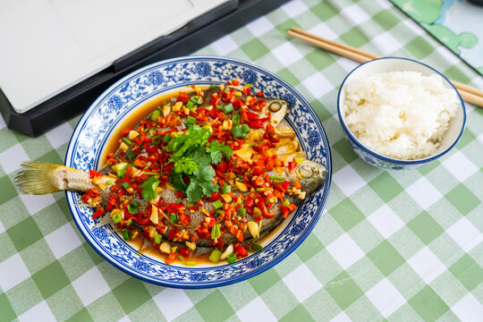 Chinese meal on the computer desk&mdash;braised yellow croaker with white rice.