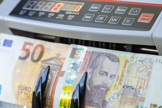 Euro vs. Bulgarian lev. An old 50 lev banknote and a 50 euro note in a money counter; a finance and business concept. Close up.