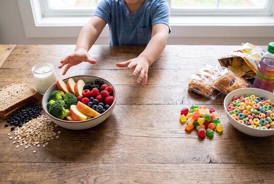 Child Choosing Whole Foods Over Ultra-Processed Snacks
