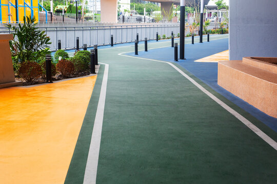 Running track in a public park, surrounded by greenery, ideal for fitness, outdoor activity, and healthy lifestyle concepts.
