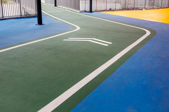 Running track in a public park, surrounded by greenery, ideal for fitness, outdoor activity, and healthy lifestyle concepts.