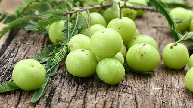 Fresh Amla (Indian gooseberry) fruits on wooden table background