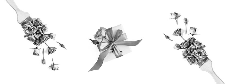 Gift box and paintbrush with roses and on a white background. Top view.