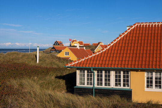 Picturesque yellow houses with characteristic white-trimmed roofs in Gammel Skagen, Denmark