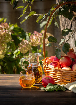 Fresh apple juice and red apples in basket