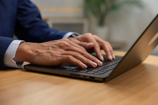 Business professional typing laptop keyboard office workspace focus productivity
