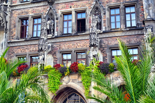 Detailed View of Munich New Town Hall Facade with Colorful Flowers and Palm Trees at Marienplatz in Germany
