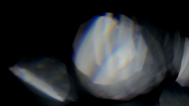 Abstract light refraction with rainbow prismatic colors on black