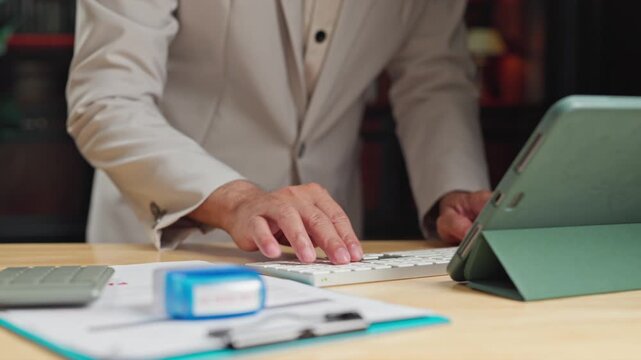 Business accountant manages accounting tasks near calculator, preparing audit spreadsheets where accountant reviews accounting records.