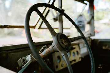 Vintage steering wheel inside old truck nostalgic atmosphere captures feeling of retro travel with sentimental and rustic charm © JK_kyoto
