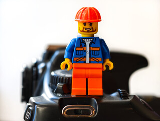 Fototapeta premium Russia, St. Petersburg, August 8, 2020 A lego man standing on top of a camera, perfect for photography or creative projects