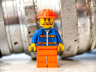 Fototapeta premium Russia, St. Petersburg, August 8, 2020 A close up of a Lego man wearing a hard hat, suitable for illustrations of construction or DIY projects