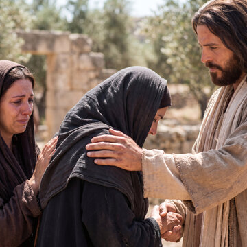 jesus christ comforting a grieving woman in a touching biblical scene photorealistic close up with soft bokeh daylight spiritual religious