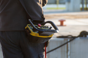 close-up of portable industrial radio remote control used for safely operating heavy machinery in hazardous environments © Olga