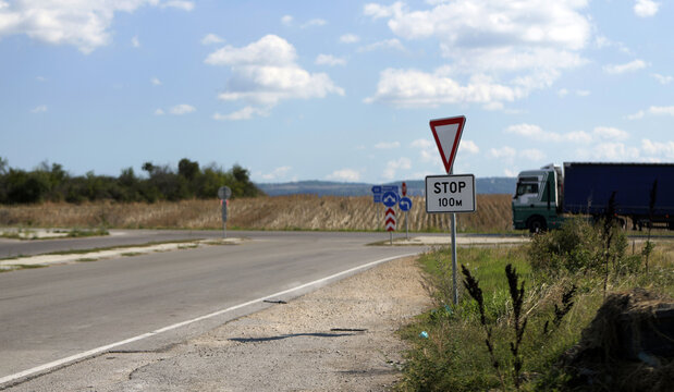 Rural intersection with stop sign and approaching truck