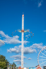 Giant Wave Swinger Carousel Ride Spinning High in the Blue Sky © Meddy Elgenedi