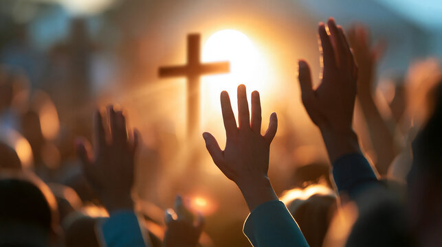 Faceless silhouettes of a diverse crowd raising hands in praise and worship toward a glowing cross, illuminated by a sunset, faith, devotion and community concept, worship