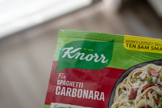 Warsaw, Poland - Sep 20, 2026: Angled view of a Knorr Fix Spaghetti Carbonara pack with a new improved recipe banner printed along the top edge of the sachet