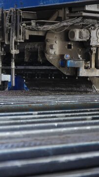 Concrete casting machine moving over steel reinforcement bars at a concrete plant