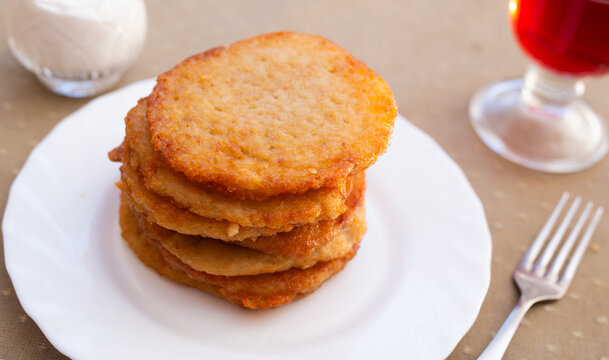 Stacked Draniki on White Plate.