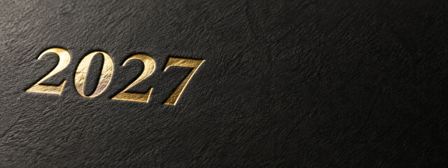 Fototapeta premium 2027 gold foil numbers embossed on black leather texture, minimal new year 2027 black gold background with copy space, elegant 2027 leather cover design, wide banner with luxury gold foil digits