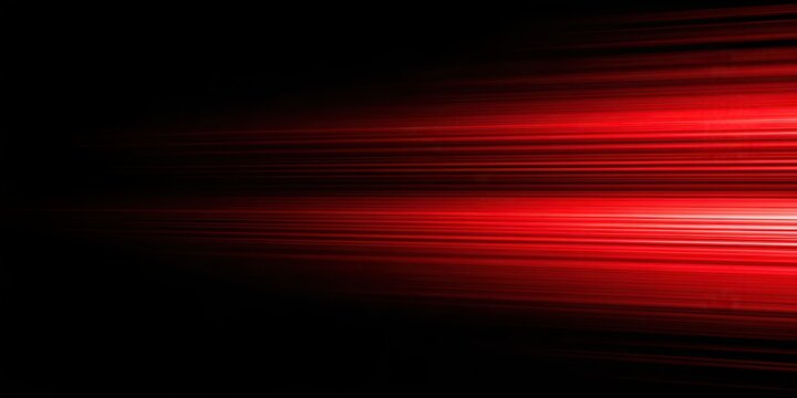 Abstract red light streaks moving horizontally across a dark background