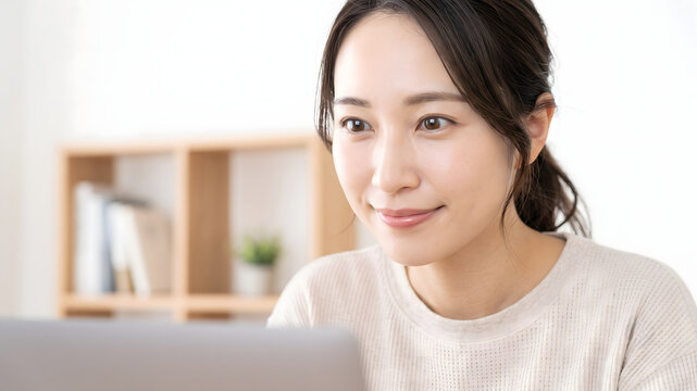 Japanese woman working on a laptop at home