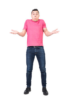 Full length of young uncertain man in t shirt and jeans shrugging shoulders and making confused face expression against transparent background