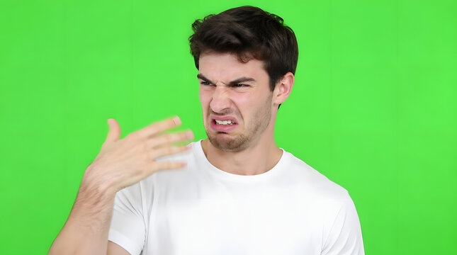 Young man expressing disgust and aversion with a hand gesture.