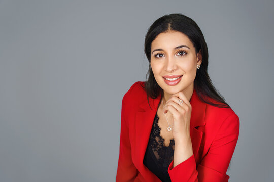 Portrait of beautyful and confident business woman in red suit.