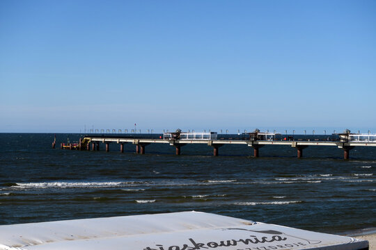 Międzyzdroje, Poland. Pier in Międzyzdroje, a 395 m long pier extending into the Baltic Sea from the beach in Międzyzdroje. It also has the status of a sea port.
