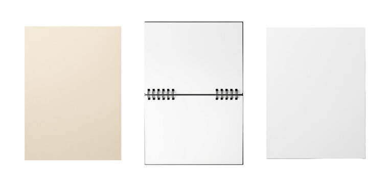 Spiral notebook pages lie open between white writing paper and a cream sheet for school notes and handwritten correspondence with blank surfaces suitable for sketching and diary entries