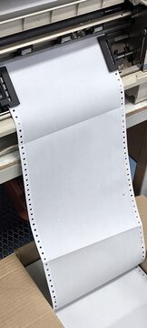 Paper in a continuous printer for printing copies.