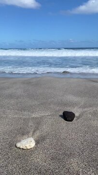 Black and white stones on Grande Anse beach at sunset, Reunion