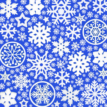 White snowflake and star Xmas pattern background design on blue. Festive seasonal cold symbols for Xmas greeting card wrapping paper. 