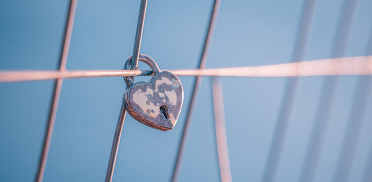 Romantic love art padlock heart shaped lock pink soft bokeh fence symbol eternal love couples valentine commitment. Conceptual love romance scene. Wedding anniversary devotion couples bond symbol