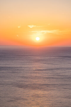 Serene golden orange sunset calm ocean glowing sun soft horizon minimal tropical sky evening summer sea. Peaceful summer sunset scene nature. Romantic relaxing meditation minimal coastal wellbeing