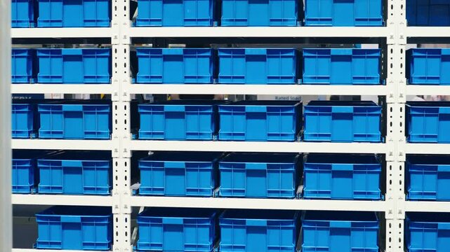 Unpacking and loading goods using automated industrial equipment in distribution center.