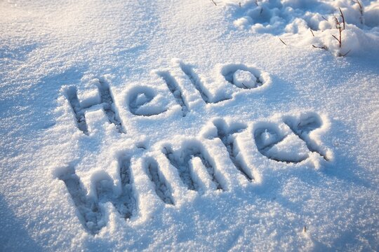 Written in the snow reads hello winter outdoors nature snowy.